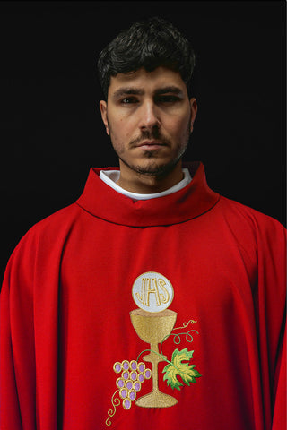 Red liturgical chasuble with embroidery of a chalice, the IHS symbol, and grapes