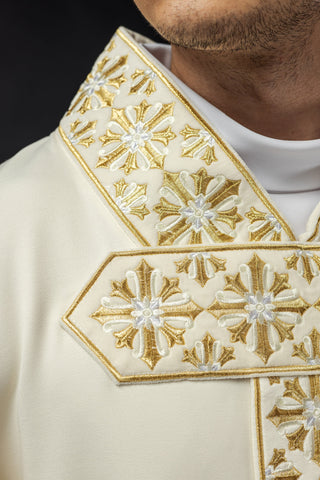 Ecru liturgical chasuble with shiny gold embroidery and satin trimming