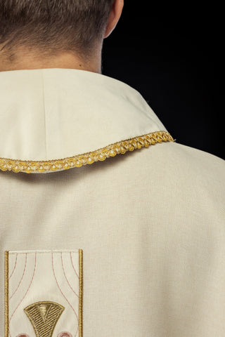 Liturgical chasuble with embroidered gold crosses and trim on the collar in ecru color