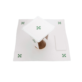 A complete set of linen chalice linens with a green cross