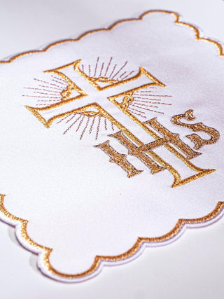 A complete set of chalice linens with gold embroidery of a cross and IHS