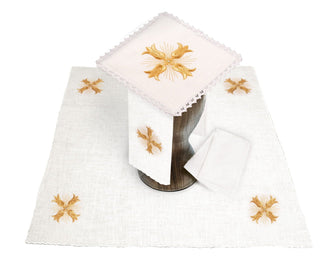 A set of linen chalice linens with embroidered golden crosses