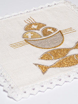 A set of linen chalice linens with a motif of fish and loaves