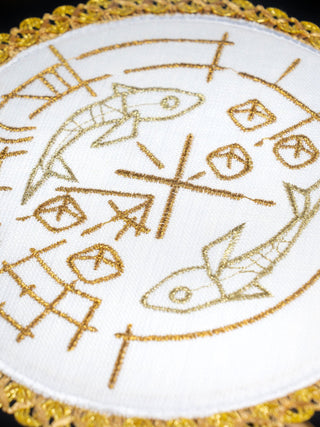 Linen chalice set with embroidery of fish, bread, and a cross on a round pall