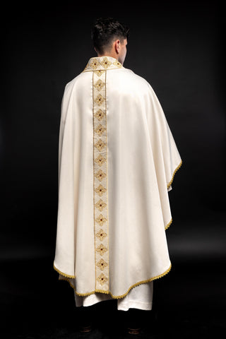 Ecru liturgical chasuble with an embroidered band and collar adorned with stones